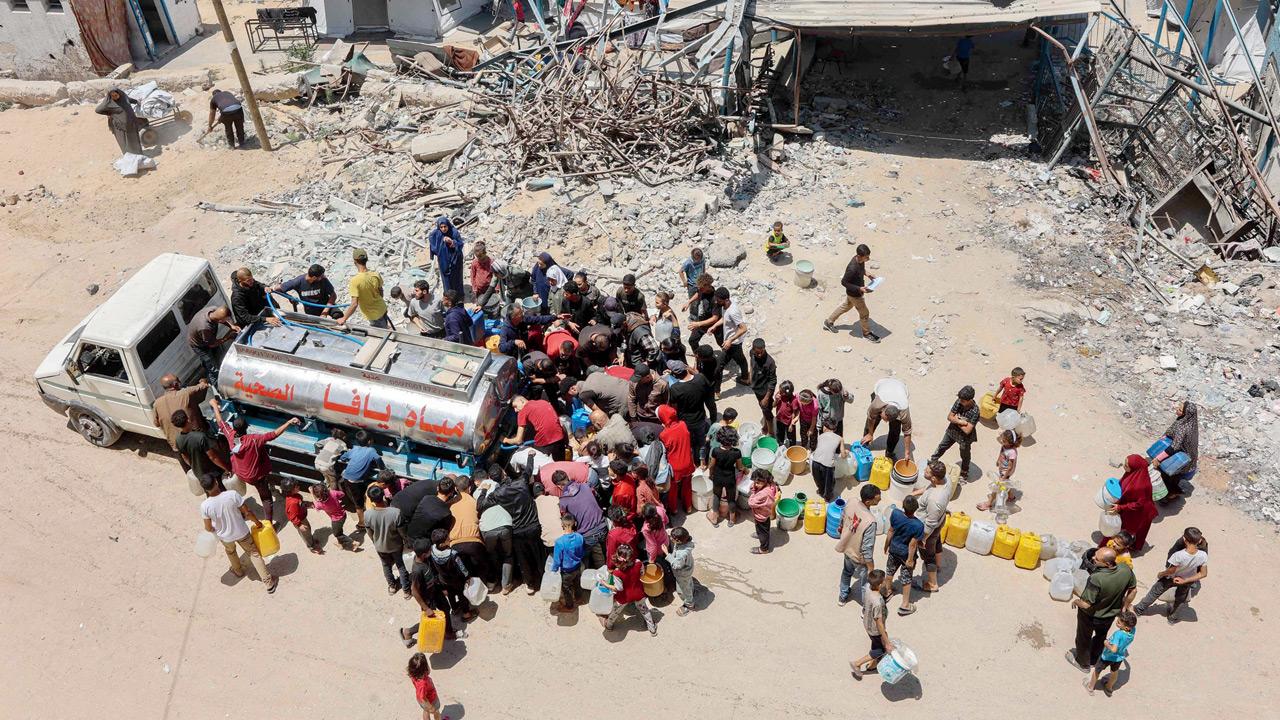 Palestinians line up to fill water in Gaza City. Pic/AFP