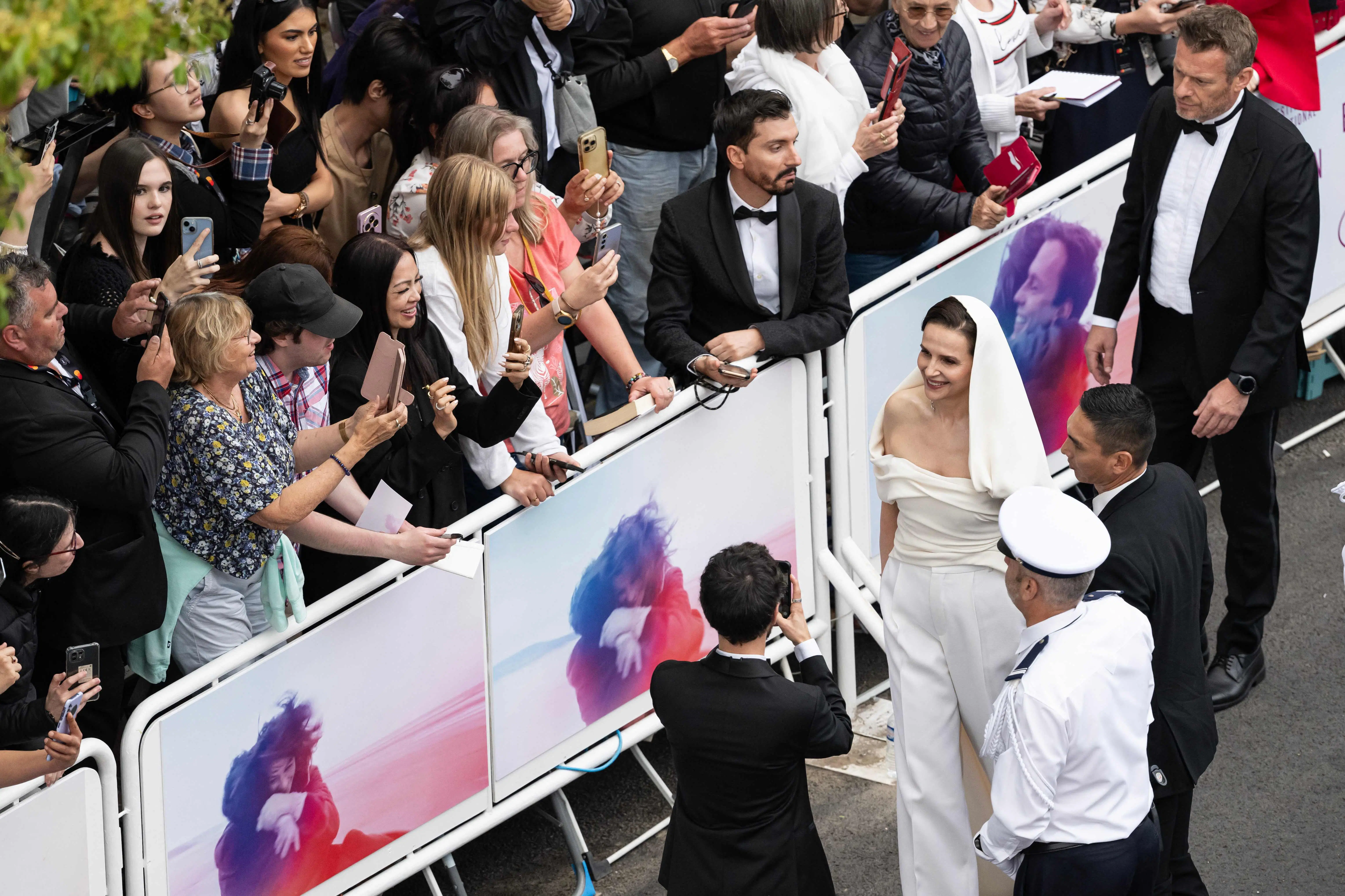 French actress and president of the jury of the 78th Cannes Film Festival, Juliette Binoche, greeted fans with a warm smile as she arrived for the Opening Ceremony. The actress looked radiant in an all-white ensemble
