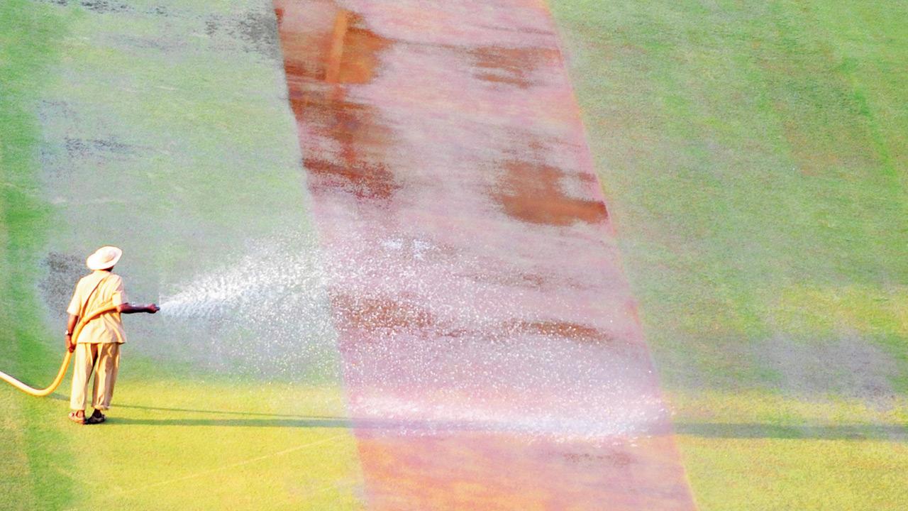 A member of the ground staff waters the pitch before a match at Wankhede. Pic/AFP