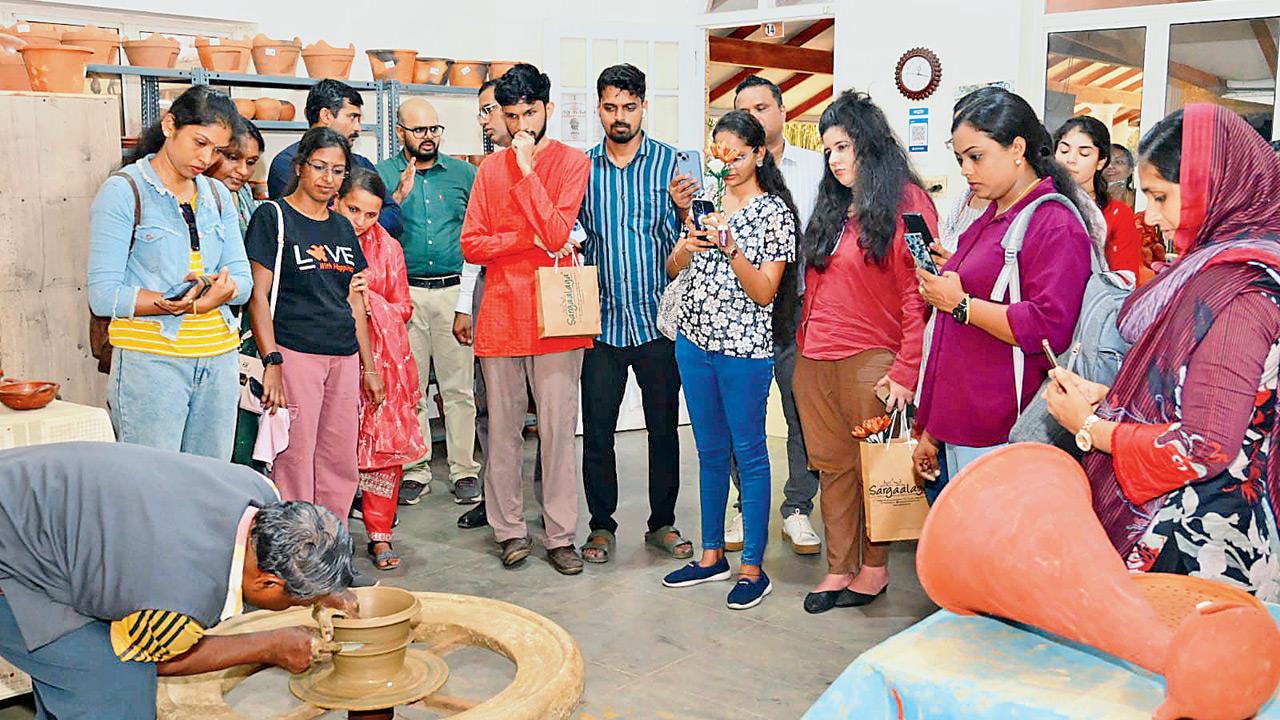 Visitors at a live pottery session in the village
