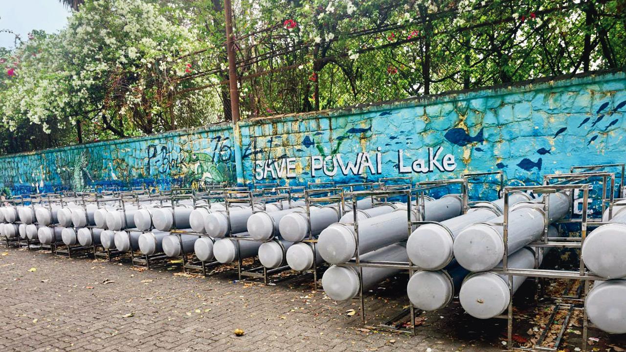 Cylinders meant for a fountain installed by BMC inside Powai Lake, lying unused near Ganesh ghat