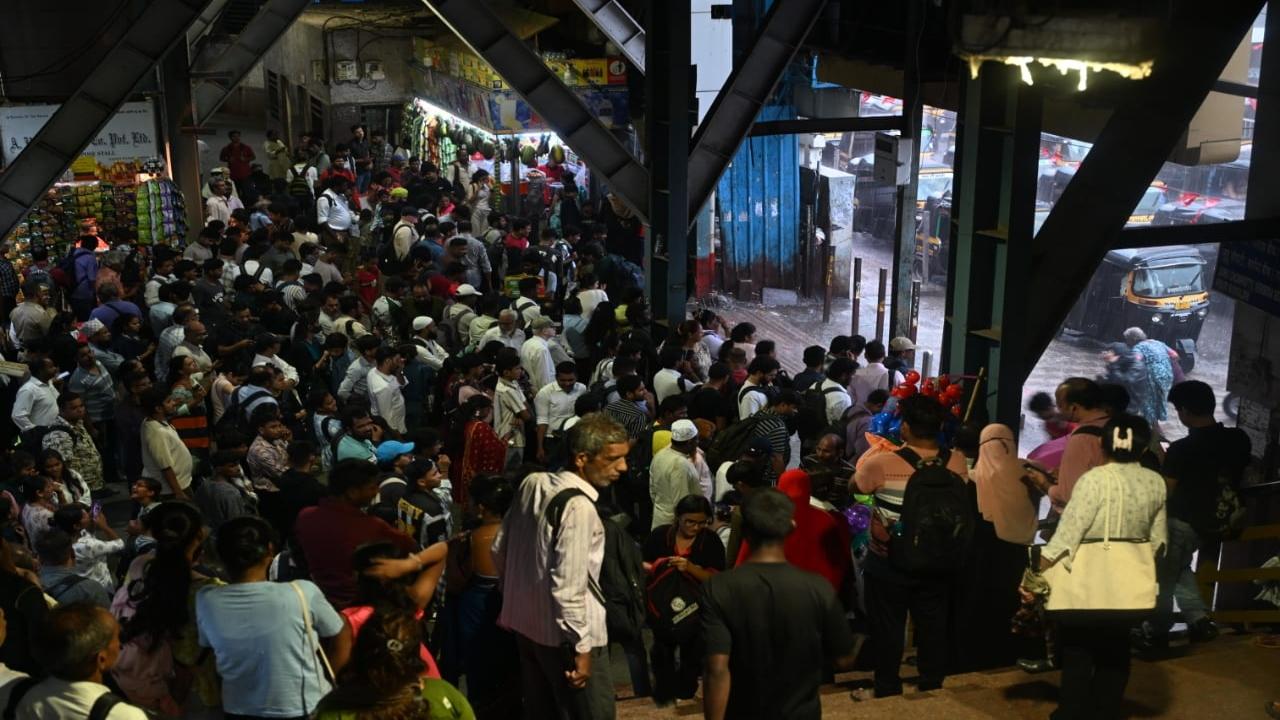 Commuters seek shelter at Andheri station during the rain. PIC/SATEJ SHINDE