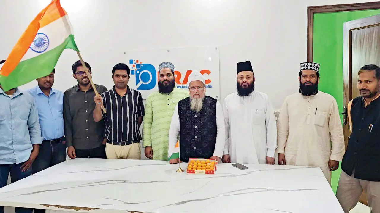 Saeed Noori (in black jacket) distributing sweets along with his group