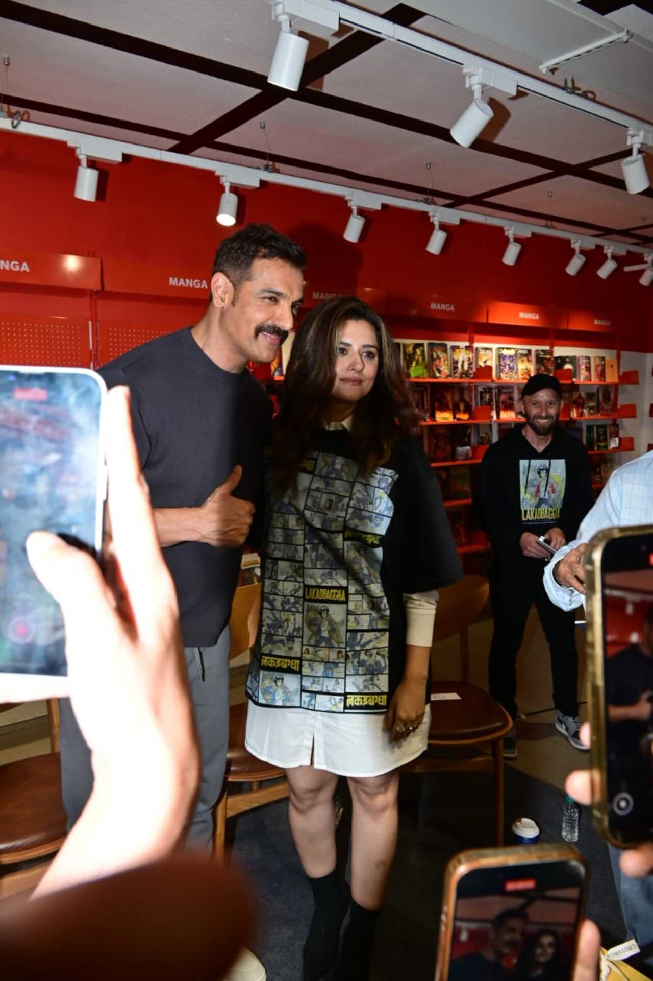 John Abraham and Ridhi Dogra were all smiles as they posed for the camera together at an event in the city amid heavy rains