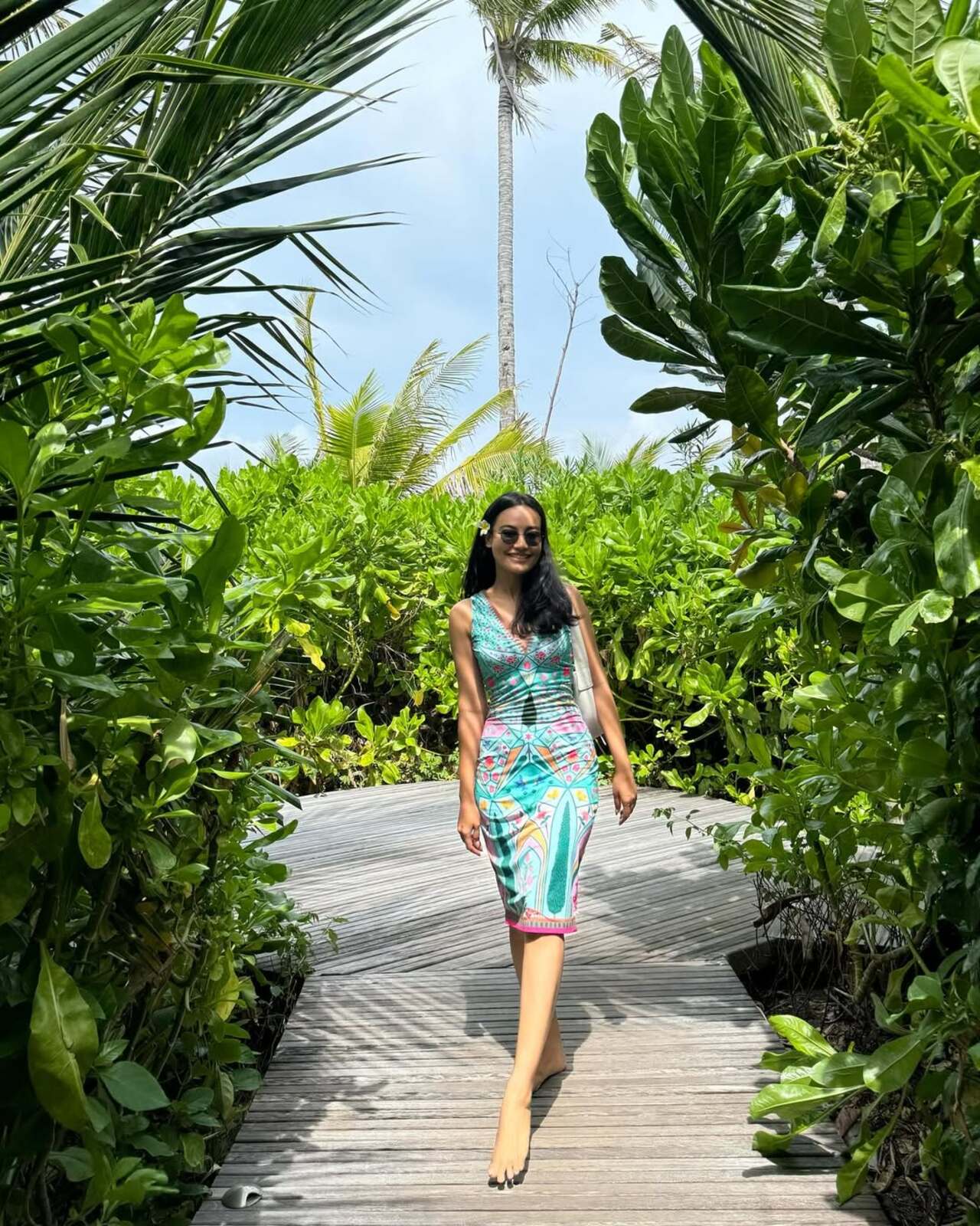 In another picture, the actress flashes a bright smile while posing against a dreamy backdrop, instantly making us want to pack our bags for a vacation