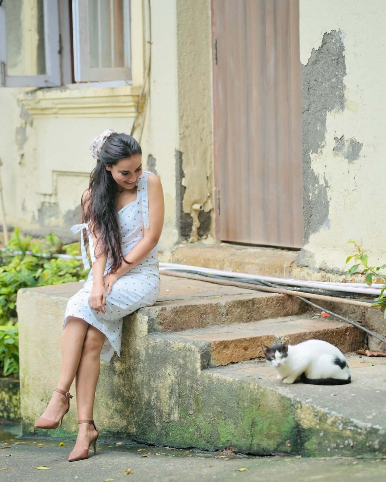 In the picture, she’s seen adoring a cat—too cute to handle. To avoid a fussy hairstyle, she tied her hair back in a loose, messy ponytail and wore minimal makeup