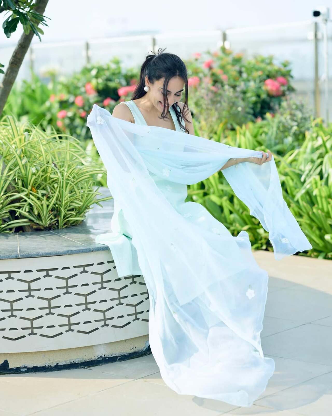 In one of her pleasing appearances, Surbhi wore a light blue strappy kurta paired with a sheer matching dupatta and pajama. To beat the heat, she tied her hair back in a high ponytail and accessorized with small studs