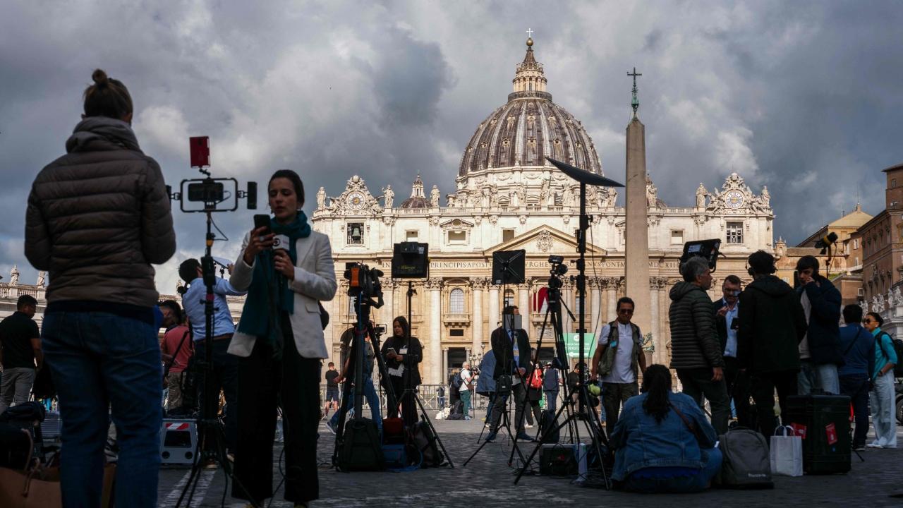 Outside in St. Peter's Square, the atmosphere was festive as thousands of people flocked to the piazza to watch the proceedings on giant video screens, applauding when the Sistine Chapel's doors slammed shut and the voting began