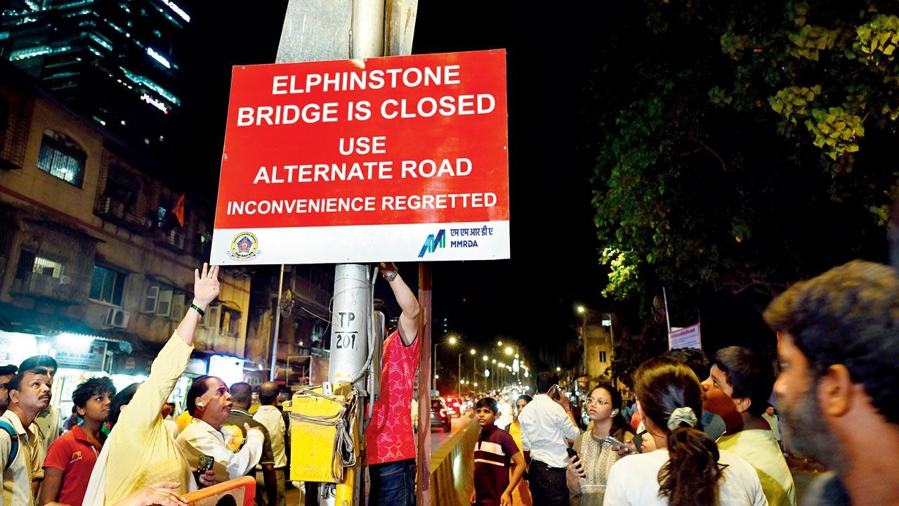 Residents pulling down the bridge closure board on April 25. File pic/Atul Kamble