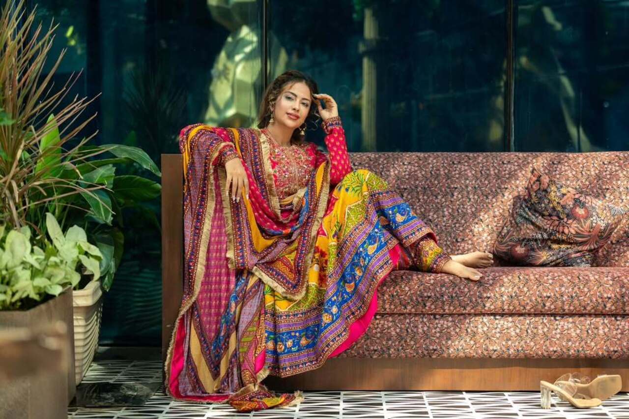 Let us woo you with the very first outfit, our favourite, a heavily embroidered multicoloured Anarkali suit. The ideal choice for any occasion, this outfit can be your best friend if you don’t like to drape a saree