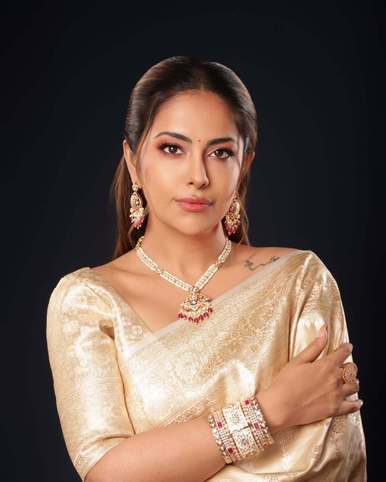 In this look, the actress wore a golden saree featuring intricate designs and detailing, paired with a light-coloured blouse. She further enhanced the look by tying her hair in a half clutch