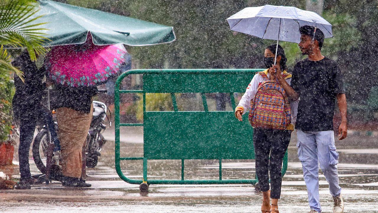 Bengaluru streets came alive with umbrellas as unseasonal showers drenched the city, catching pedestrians and motorists by surprise