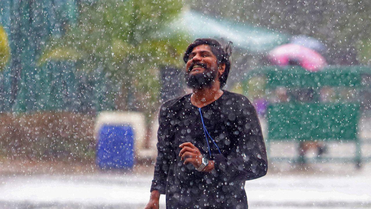 A youngster walks amid rain at Lalbagh, in Bengaluru's Karnataka