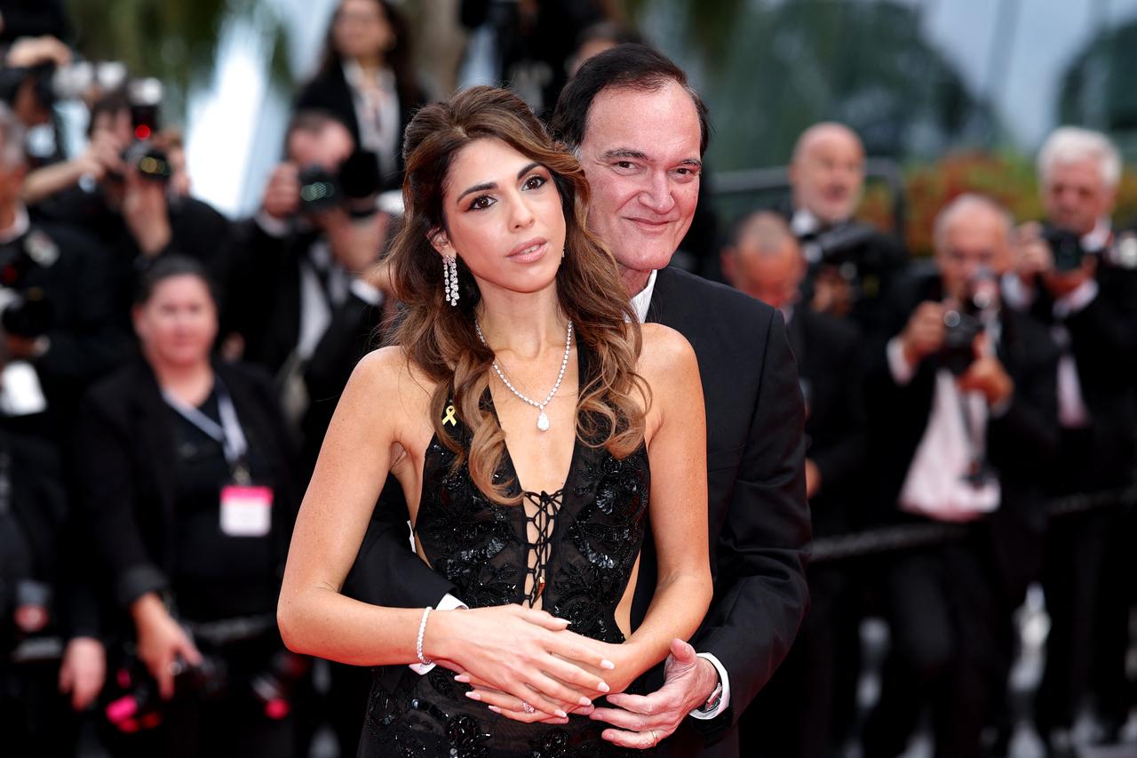 Legendary filmmaker Quentin Tarantino strikes an affectionate pose with wife Israeli singer Daniella Pick