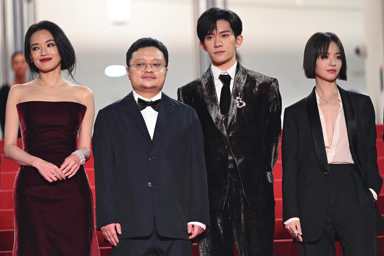 Taiwanese–hong kong actress Shu Qi, Chinese director and screenwriter Bi Gan, Chinese actor Jackson Yee and Chinese actress Gengxi Li arrive for the screening of the film 'Kuang ye shi dai' (Resurrection) at the 78th edition of the Cannes Film Festival