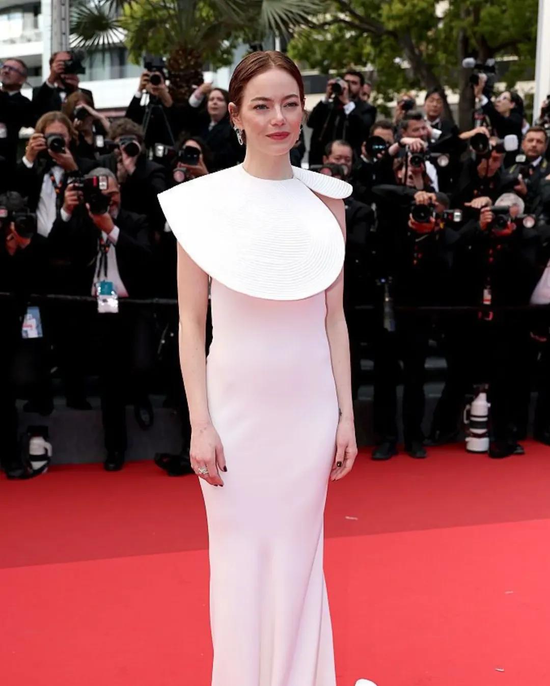 Emma Stone turned heads in a white A-line gown featuring dramatic sleeve cut-outs. Her effortless grace and confident presence lit up the red carpet at the Cannes Film Festival