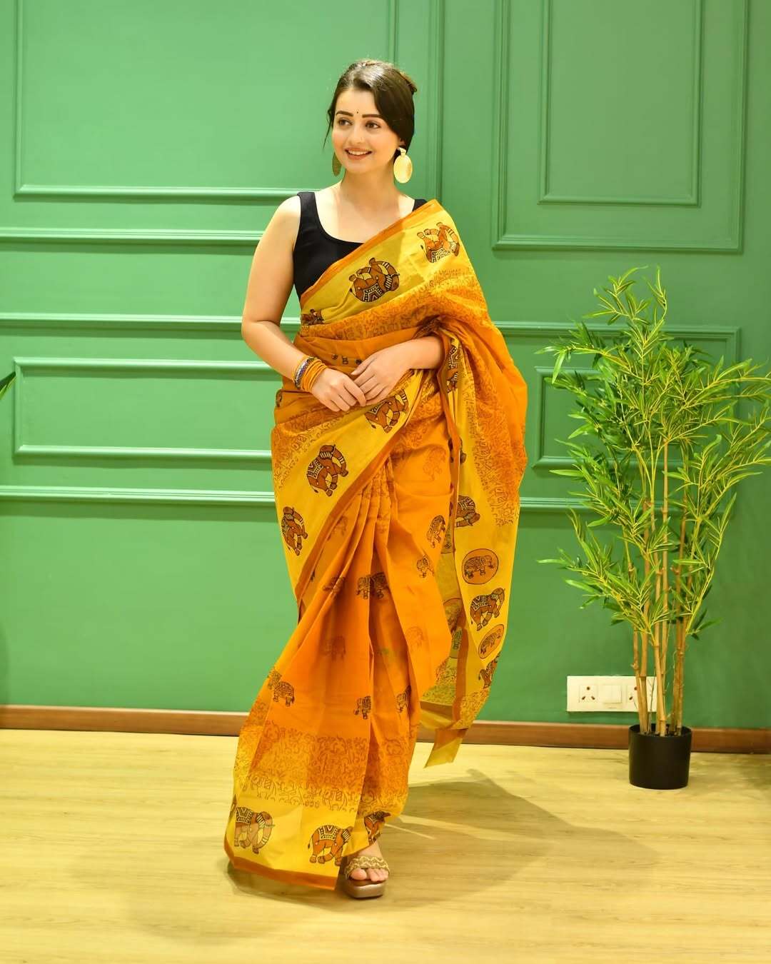 Chahat Pandey made jaws drop as she wore a gorgeous orange and yellow block-printed saree, paired with a contrasting black strappy blouse