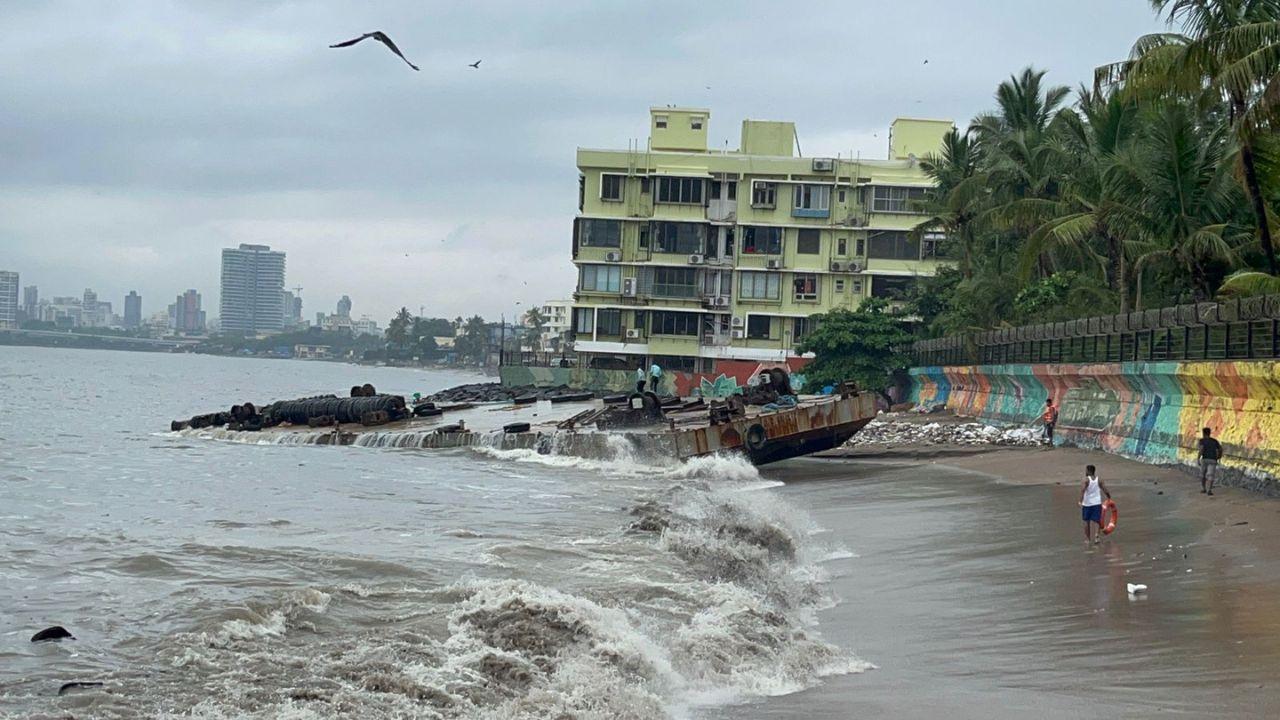The skyline of Mumbai stood stark against this moody backdrop, with high-rise buildings looming in the distance, their outlines softened by the misty air