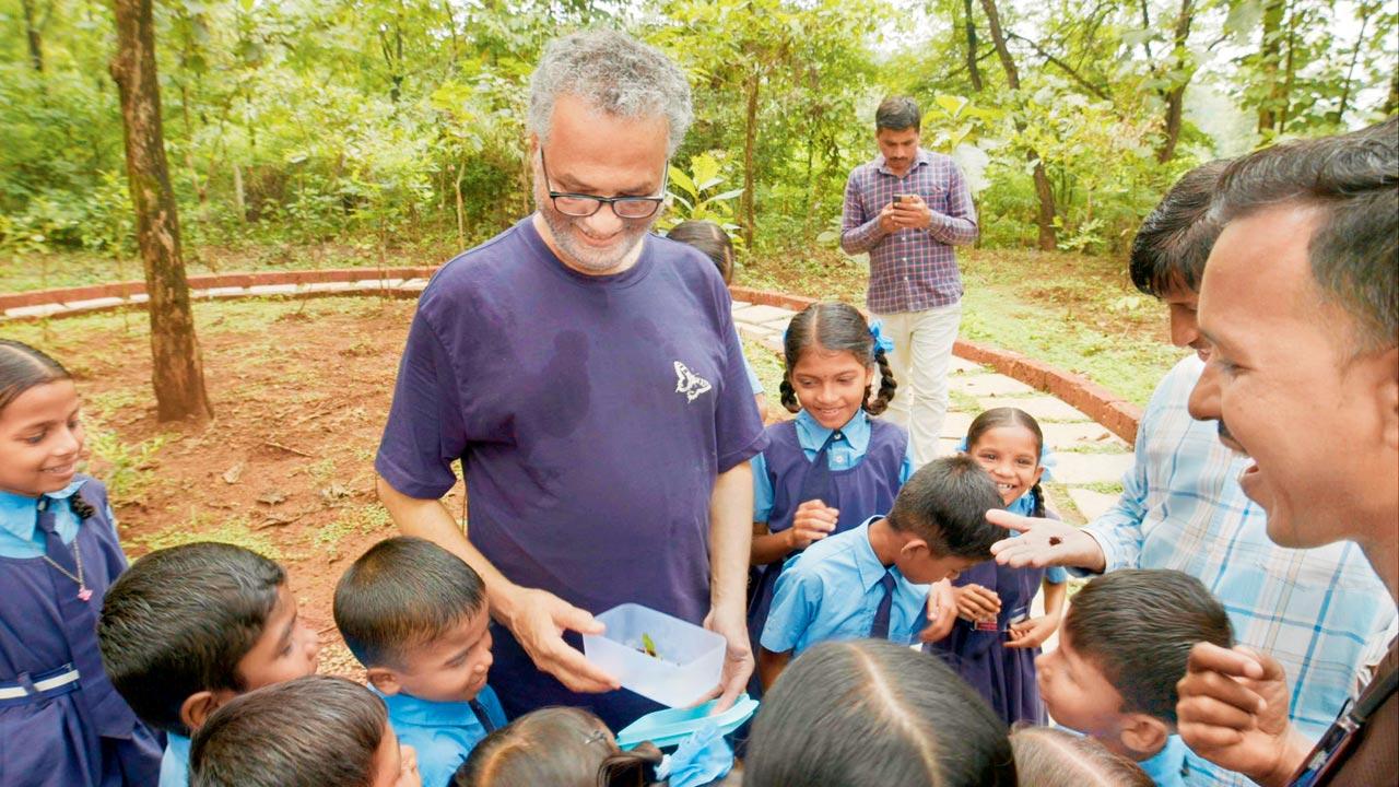 Isaac Kehimkar (in purple) with students of Saraiwadi Primary School at his garden in Karjat
