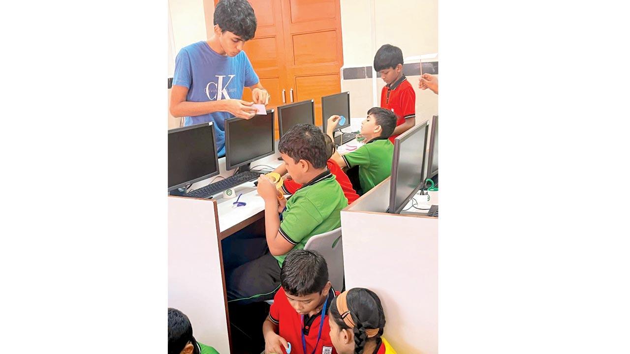 Aryan Agarwal (in blue) guiding students