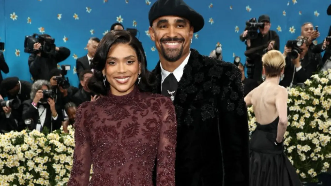 Jalen Hurts, quarterback for the Philadelphia Eagles, appeared with his new wife Bryonna. He wore a velvet black suit with floral detailing and a beret, while she dazzled in a red beaded gown with tassels