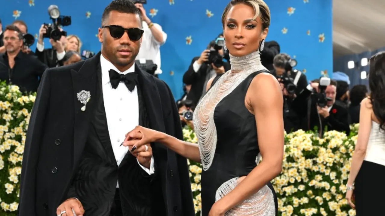 Russell Wilson, now with New York Giants, attended with wife Ciara. He chose a sleek black suit and cane, while Ciara wore a dramatic black gown accented with silver chains.
