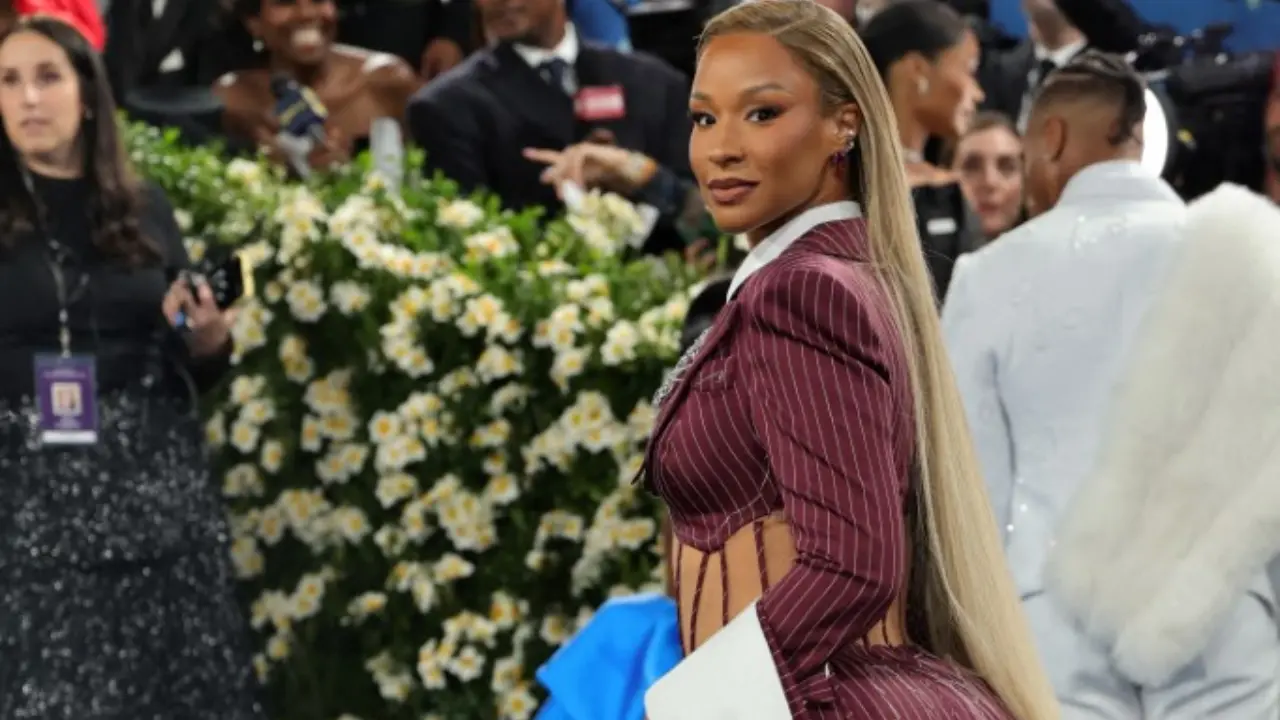Savannah James, attending in place of her husband LeBron, captivated in a striped suit with a dramatic mermaid skirt, fusing structured tailoring with a touch of glamour