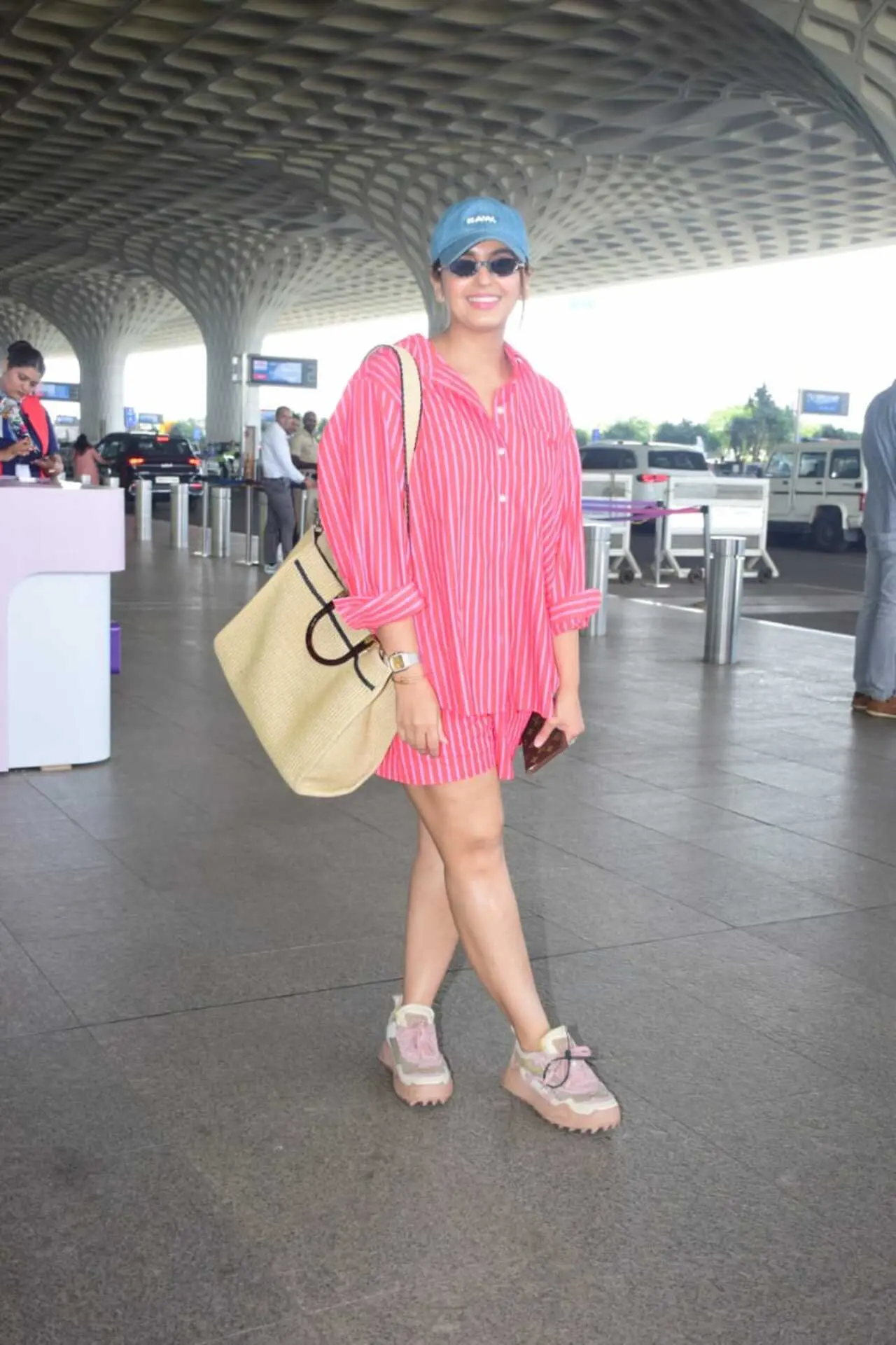 Huma Qureshi was spotted in a loose fitted pink shirt dress at the airport. She completed her look with a cap and black shades to protect herself from the sun