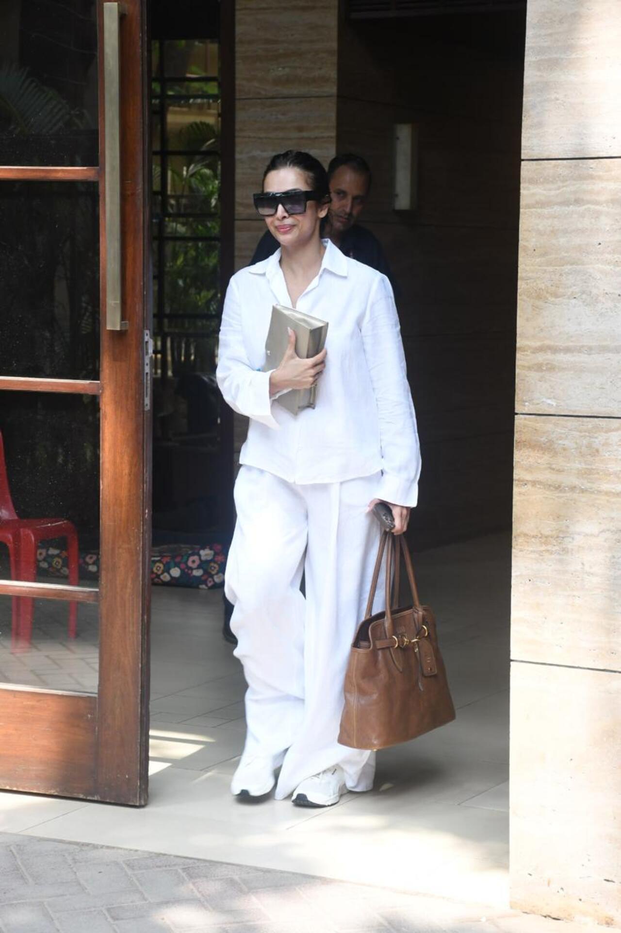 Malaika Arora was spotted in an all-white outfit as she stepped out of her house on Thursday afternoon