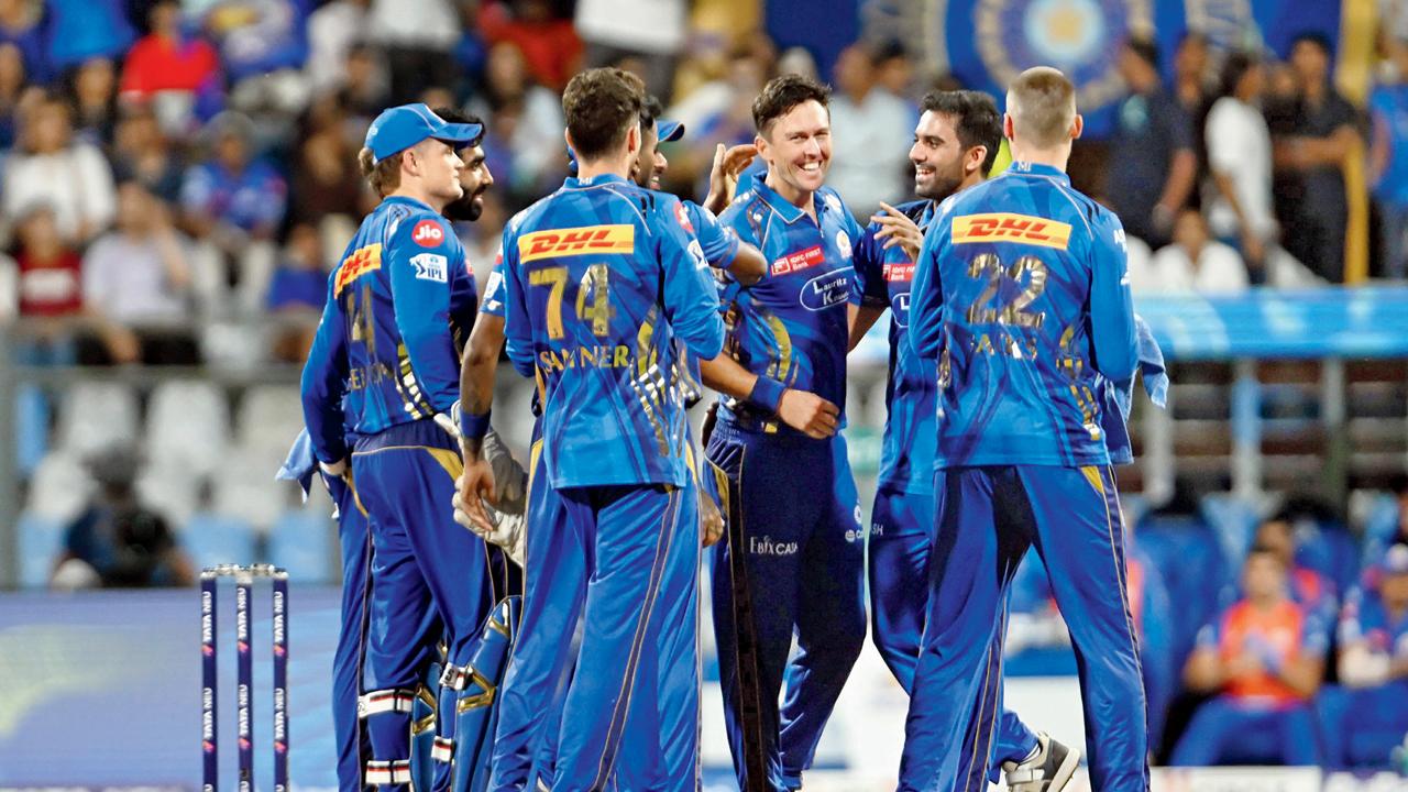 MI players celebrate the wicket of DC opener KL Rahul