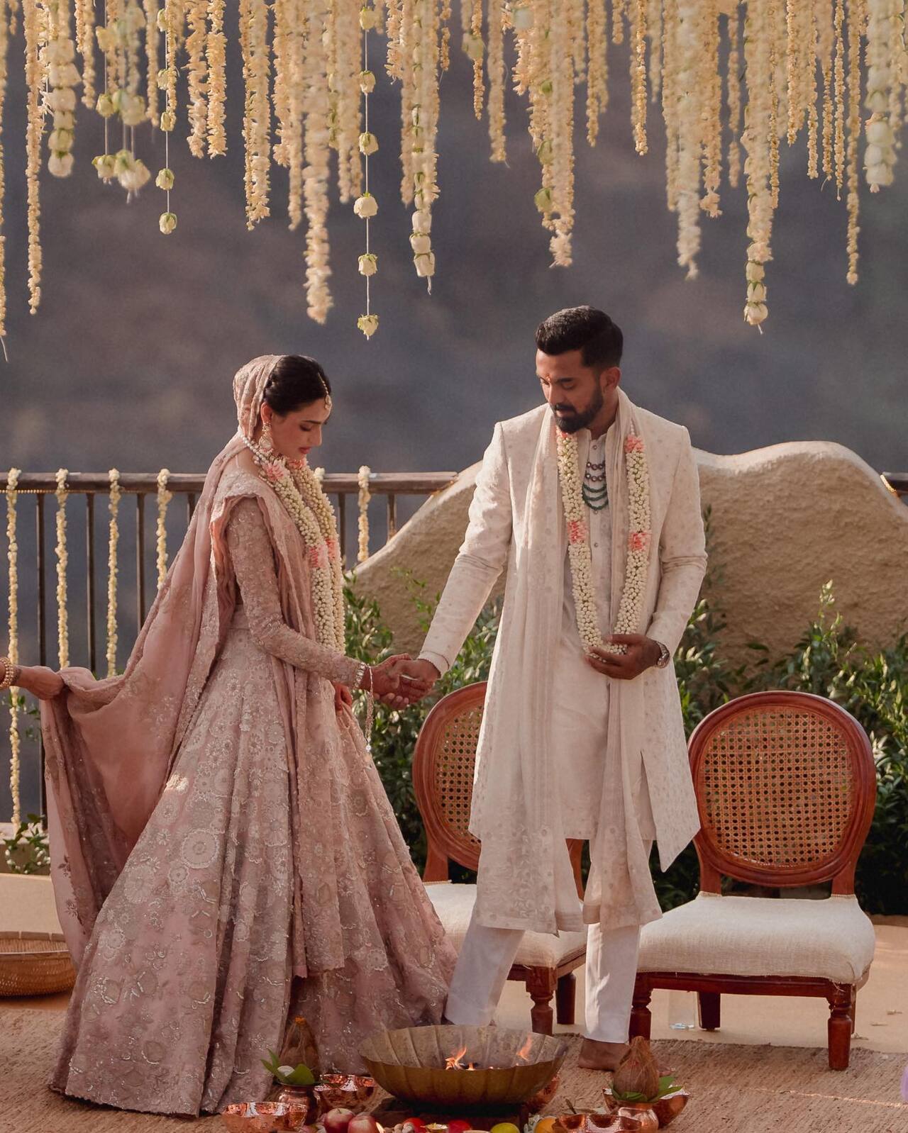 For her nuptials, Athiya wore a blush pink chikankari lehenga by designer Anamika Khanna, which was decorated with delicate chikankari, zardozi, and jaal works featuring floral embellishments and embroidery all over. The actress completed her look and gave it a Western touch by wearing a silk-organza veil.