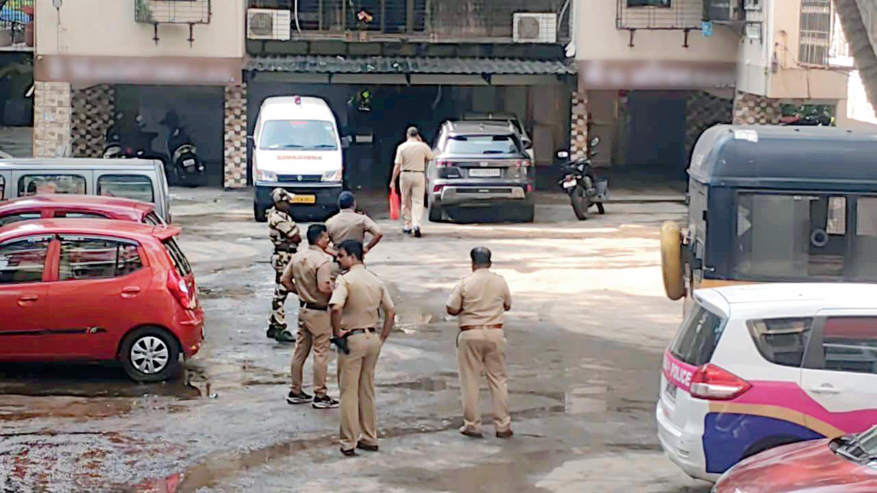Mumbai: 27-year-old domestic help found dead in Antop Hill flat Investigators at the spot where the body was found; Police personnel stationed outside the Antop Hill building after the incident. Pics/By Special Arrangement