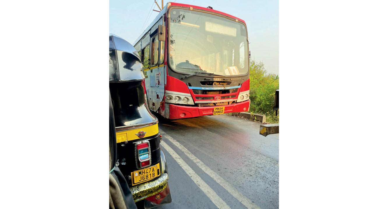 A bus navigates a narrow lane