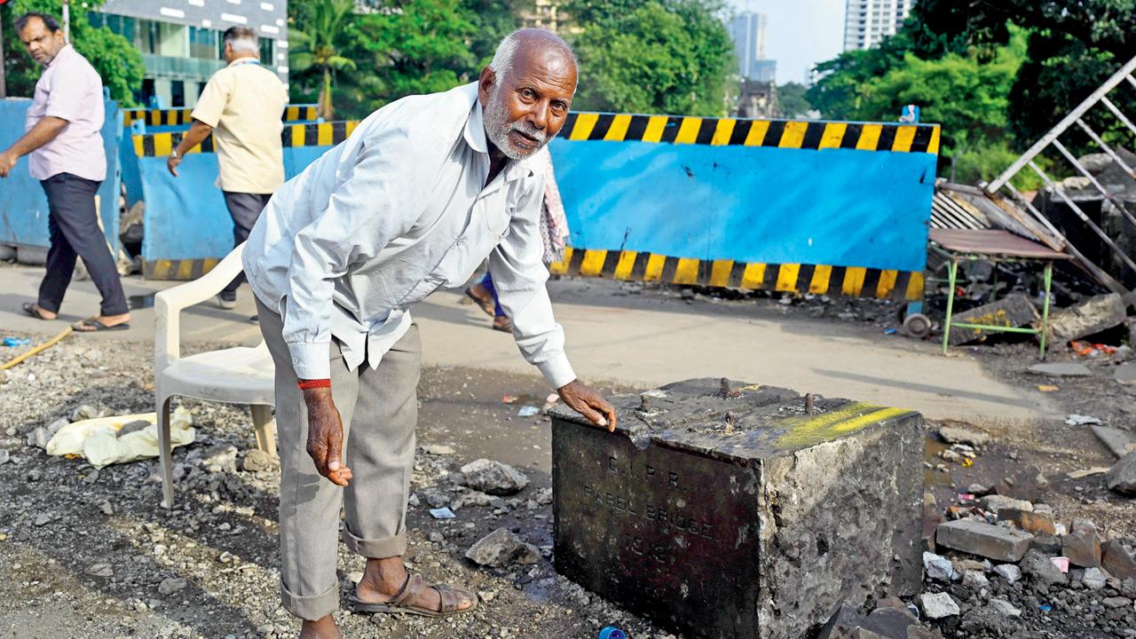 Mumbai: Elphinstone bridge’s 1913 plaque damaged during demolition Lala Prajpati, a watchman in Parel, cleared the plaque of posters that have been stuck on it; (top) The damaged 1913 stone plaque on Elphinstone bridge. PICS/ASHISH RAJE