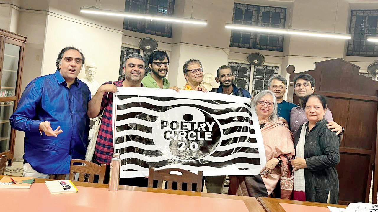 Poet Anand Thakore and Nitin Mukadam’s wife and son, along with older and newer members, showcase the Poetry Circle banner