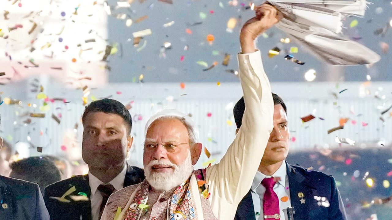 Prime Minister Narendra Modi waves a ‘gamcha’ (towel) as part of the celebration of NDA’s victory in the Bihar Assembly elections on Friday. Pics/PTI