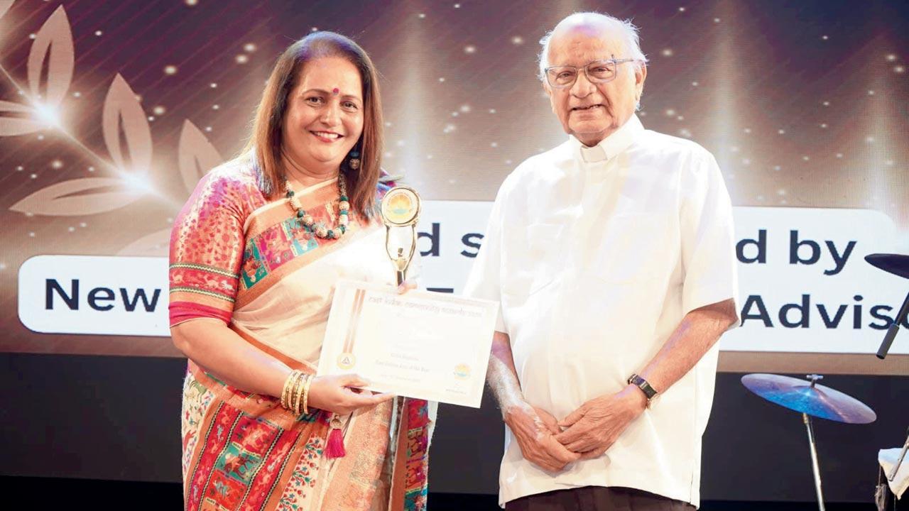 ACP Mamta Lawrence D’souza (left) receives her award from Father Vernon Aguiar. Pic Courtesy/MGP