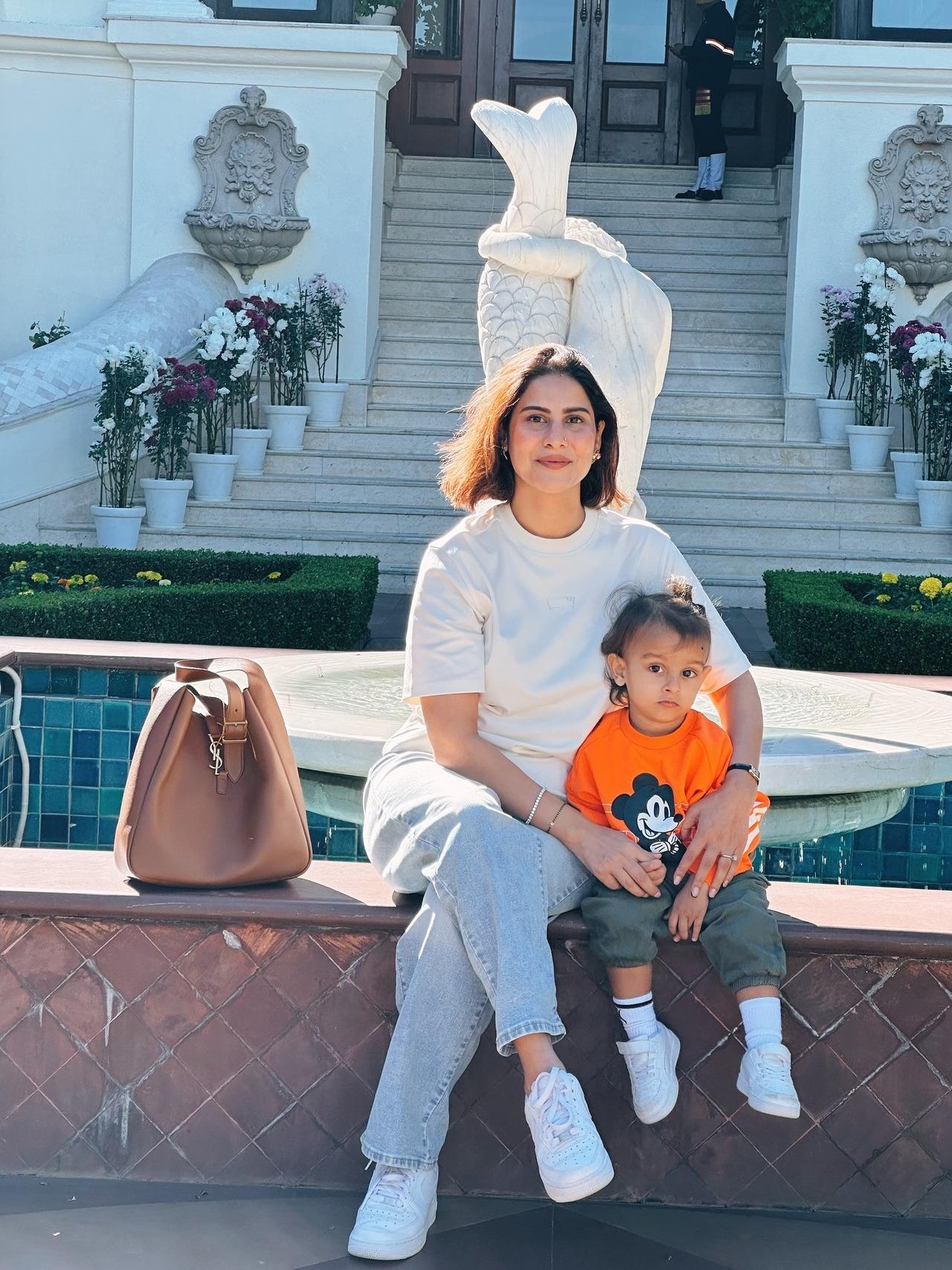 <p>Vikrant turned photographer for his wife and son, who posed for a picture near a fountain.</p>