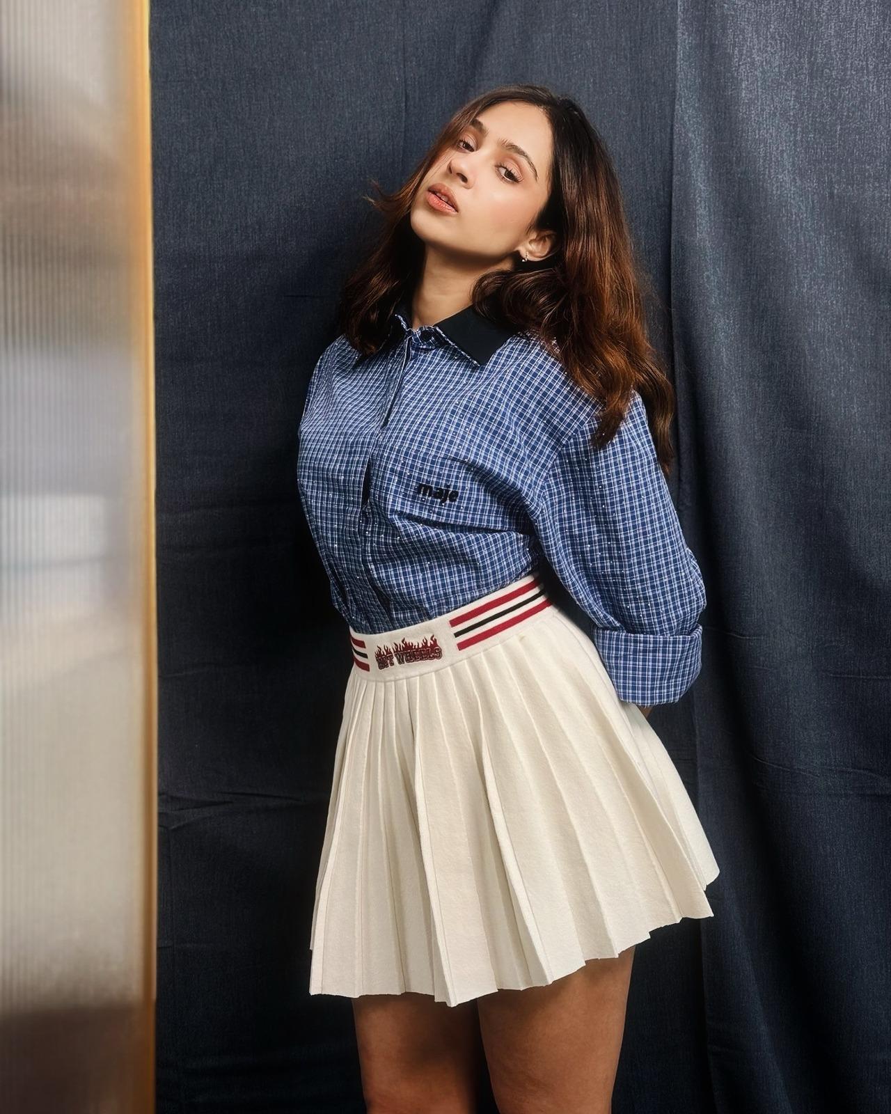 Pashmina gets sporty in a blue checkered Maje shirt tucked into a white pleated mini skirt. She ditched the accessories while making it playful with Hot Wheels detailing. 