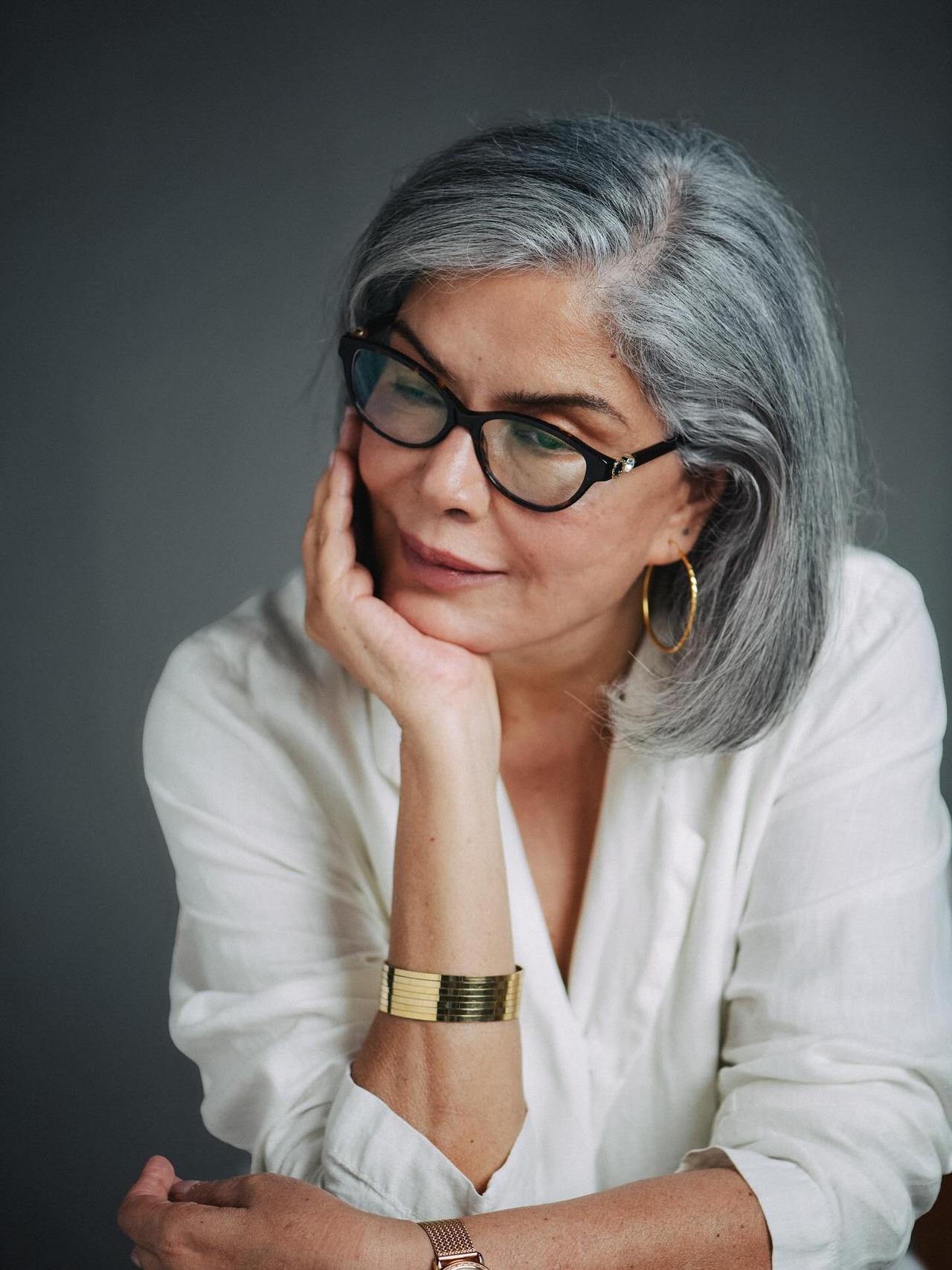 Shining bright in her silver bob hairstyle, Zeenat keeps it simple yet sophisticated in this white shirt paired with glasses and a golden statement bangle.