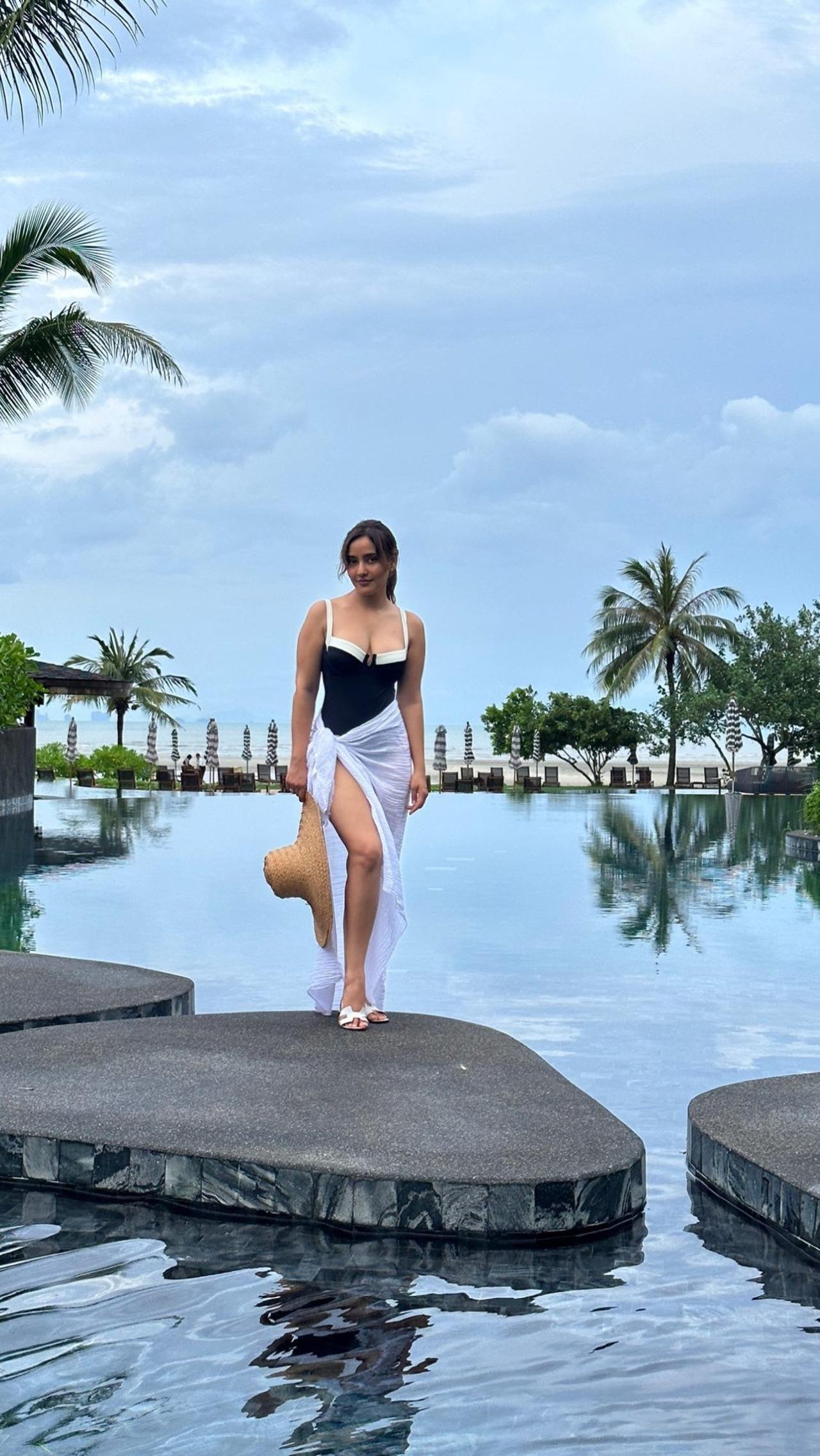 Neha manages to look chic even when heading out for a swim in this black and white one-piece swimsuit. 