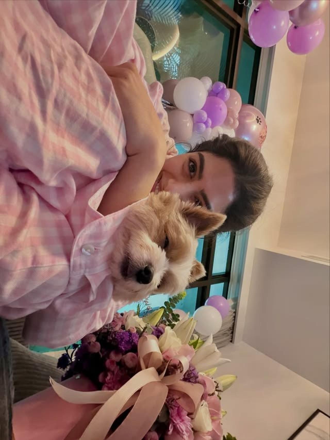 Khushi also shared a picture cuddling with her pet dog, surrounded by flowers and balloons.