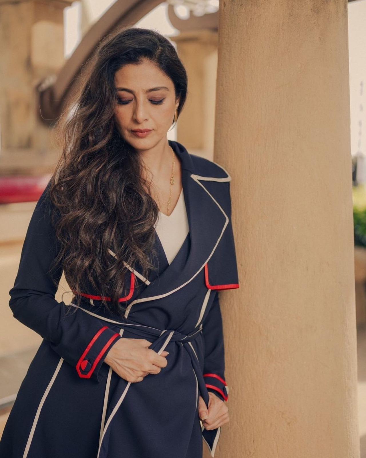 Tabu slays in this wrap-around overcoat that's stylish and edgy. It features white and red lining adding a dash of colour and drama.