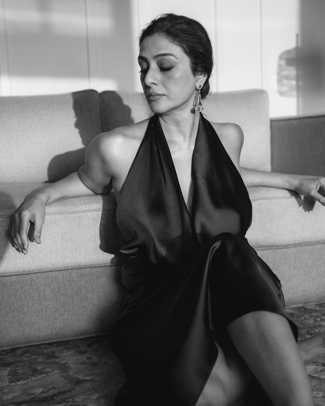 Tabu serves sexiness and confidence in this picture, sporting a satin outfit with a plunging neckline.