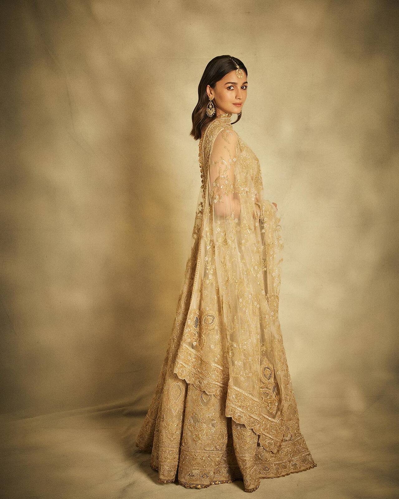 Alia Bhatt looked ethereal in a net lehenga featuring intricate gold embroidery and delicate sequin work, a perfect pick for Diwali celebrations. She completed her festive look with traditional jhumkas and a maang tikka, keeping her makeup soft and radiant.