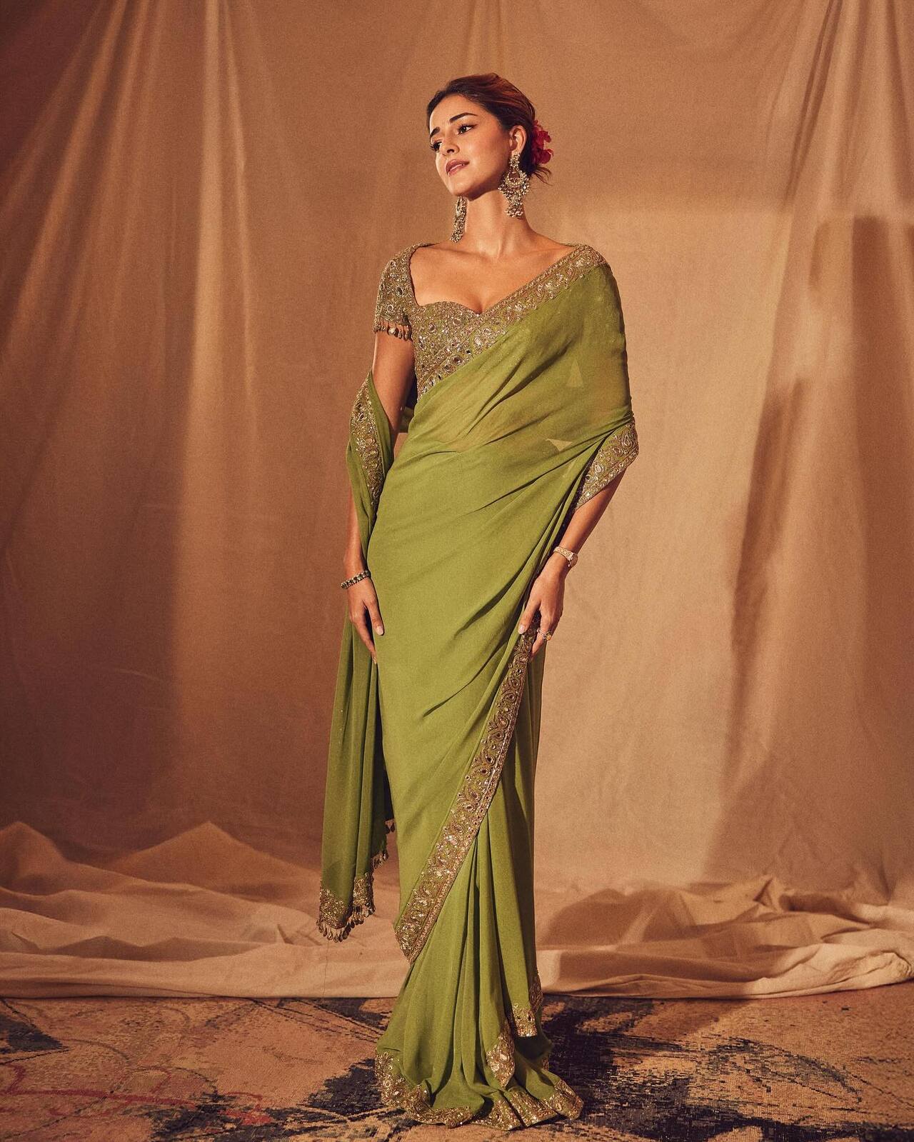 Ananya Panday looks radiant in this olive-green saree that oozes understated glamour. 