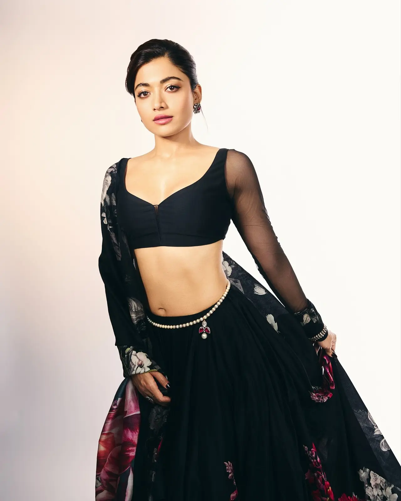 Rashmika Mandanna kicked off Thamma promotions in a sweeping black lehenga bursting with oversized florals in red, ivory, and grey.