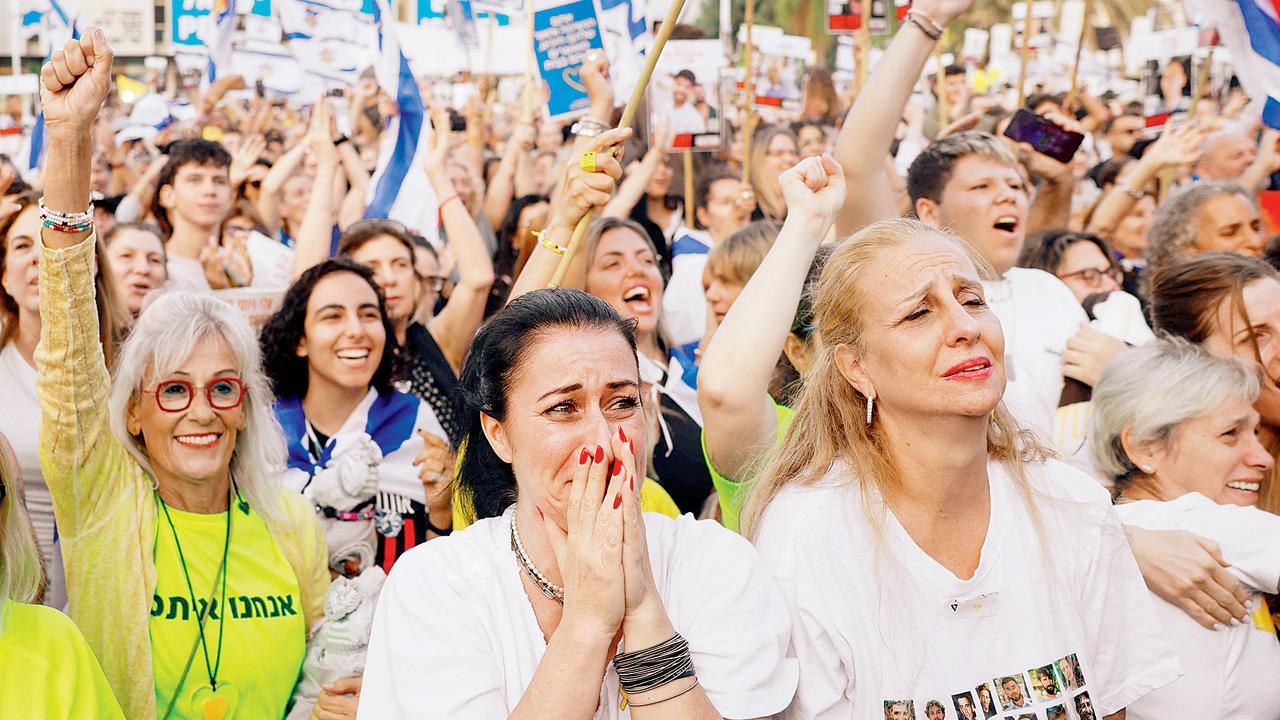 People react in Tel Aviv to news of the hostages being freed by Hamas. Pic/AFP