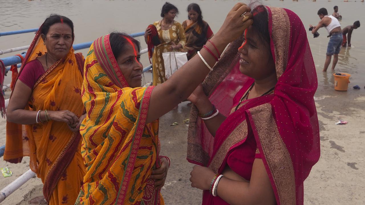 KolkataPeople performing rituals during the Chhath Puja festivities, at Babughat.