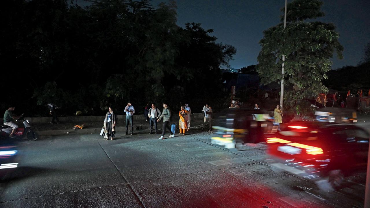 Commuters forced to cross the road in the dark, amid traffic